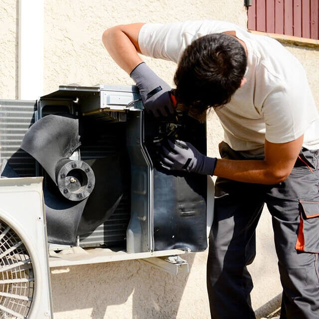 Air conditioner repairmen work on home